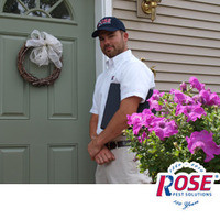 Residential Pest Control From Rose Pest Solutions Rose Pest Solution's technician standing at a door